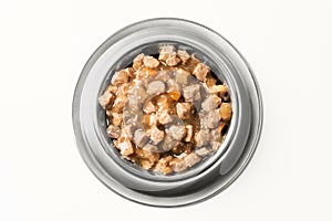 Wet food for dogs and cats in silver bowl