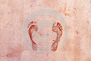 Wet footprint of male feet on concrete flooring surface