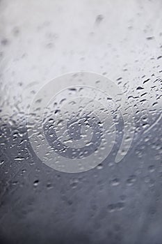 Wet glass with raindrops on a stormy day