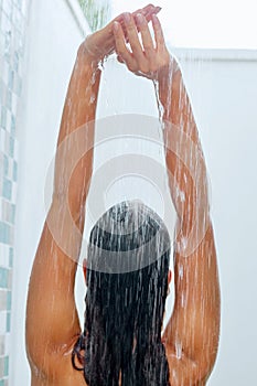 Wet hair. Woman washing her hair with shower.