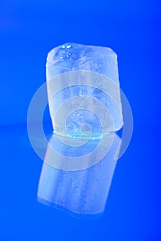 Wet ice cubes on blue background