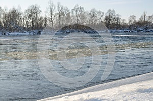 Wet icy flowing in river