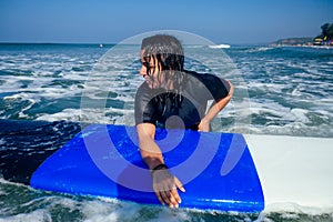 Wet indian woman on surf waiting a big wave in Goa sea