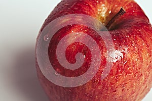 Wet Juicy Red Apple Close-up on white background