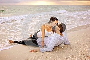 Wet lovers on the beach at sunset