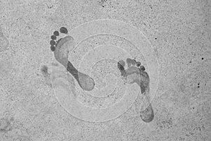 Wet male footprints on concrete surface