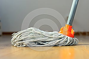 Wet mop on wooden floor