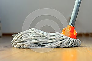 Wet mop on wooden floor photo