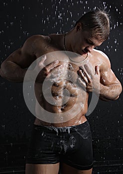 Wet muscle young man take a shower