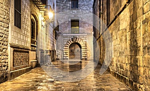 Wet narrow street in gothic quarter, Barcelona