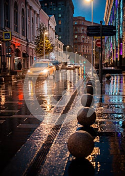 Wet night city street rain Bokeh reflection bright colorful lights puddles sidewalk Car