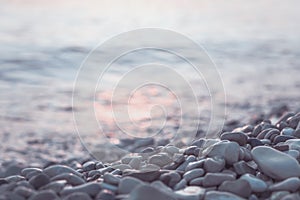 Wet pebble stones and water at morning seaside