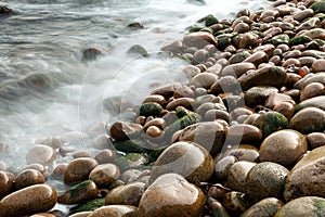 Wet pebbles on beach