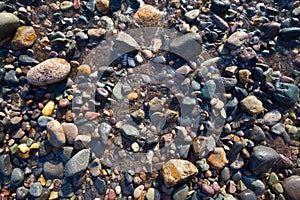 Wet pebbles on beach