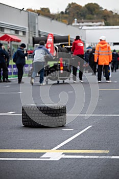 Wet race concept, motorsport car rain tires on asphalt circuit starting line grid