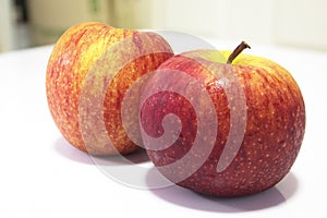 Wet red apple isolated on white