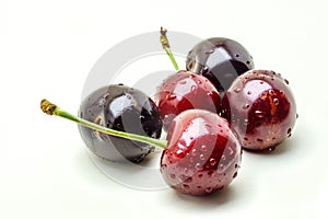 Wet ripe fresh cherries isolated on white background.