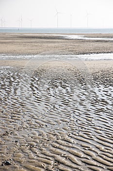 Wet rippled sand on beach