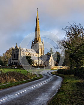 Wet road leading towards Snettisham church (Norfolk, England