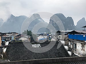 wet roofs of Yangshuo Town and mountains