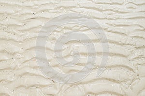 Wet sand at beach coastline texture background.wave form.