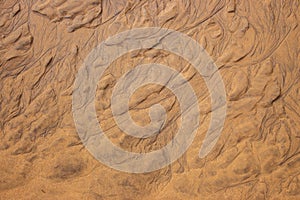 Wet sand texture. Beige sand macro. Dune background close up. Terrain pattern.