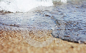 Wet sand and waves on the sea