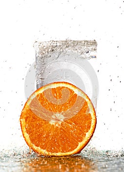 Wet slices of orange and a glass