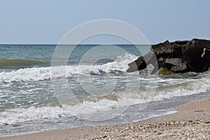 Wet stones and waves. Background of sea stones and the sea serf for design