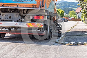 Wet street cleaning with sweeper - close-up