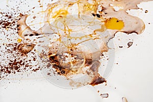 Wet surface, sprinkled with brown powder cacao, spilled milk foam, viscous honey, abstract background