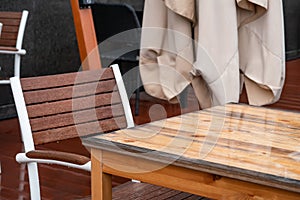 Wet table and armchair in an outdoor cafe in the rain, autumn 2020, background, Moscow