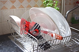 Wet umbrella is drying in a dish rack.