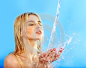 Wet woman face with water drop.