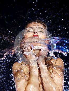 Wet woman face with water drop.