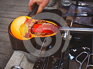 Wet wooden blocks create a layer of steam when in contact with hot glass photo
