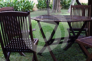 Wet wooden table and chairs in the garden