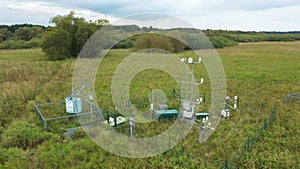 Wetlands science station research for studying meadows, drone aerial video shot ecosystem weather station swamp willows