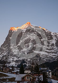 The Wetterhorn mountain in the background with the Grindelwald Church in the foreground. Photographed at dusk in blue hour.