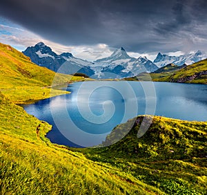 Wetterhorn and Wellhorn peaks reflected in water surface of Bach