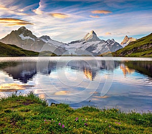 Wetterhorn and Wellhorn peaks reflected in water surface of Bach