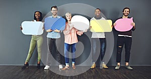 Weve all got our own opinions. Studio shot of a diverse group of people holding up speech bubbles against a gray