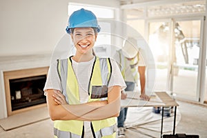 Weve designed your perfect home. Shot of an attractive young construction worker standing in a house with her arms