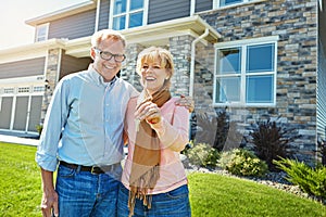 Weve found the keys to our happiness. Portrait of a happy senior couple posing outside their new home.