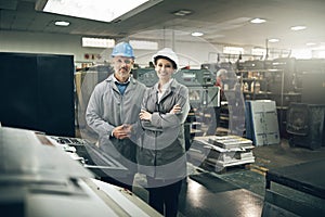 Weve got your printing needs covered. Portrait of two managers standing inside a printing and packaging plant.