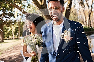 Weve made so many special moments today. a happy newlywed young couple getting showered with confetti outdoors on their