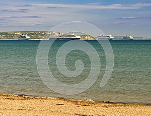 Weymouth beach with cruise liners moored in the bay