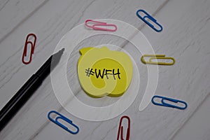 #WFH - Work From Home write on sticky note isolated on wooden table