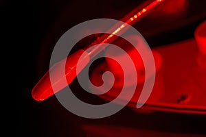 Whammy bar of an electric guitar in red light