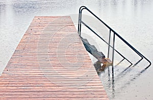 Wharf on lake in rain